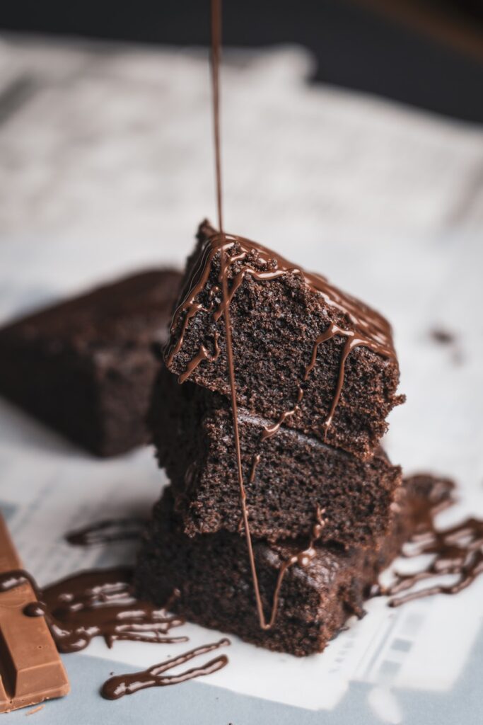Freshly cut fudgy chocolate brownies stacked on a marble board